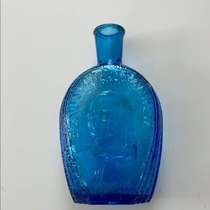 Vibrant Blue Glass Art Bottle with Intricate Embossing